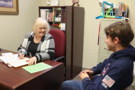 Melessia Mathis, assistant professor of education, meets with a student in her office. - Photo by Kristi McMurry Woody