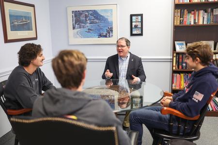 John Foubert, dean of the college of education, chats with students in his office. - Photo by Kristi McMurry Woody