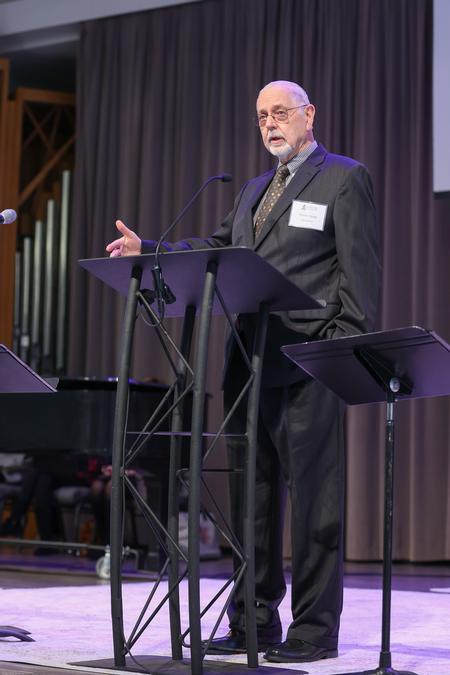 Thomas Baugh, class of 1972, welcomes guests to Homecoming chapel. - Photo by Kristi McMurry Woody