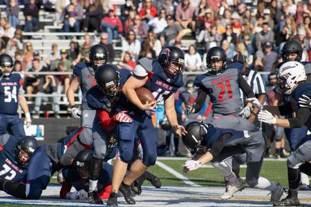 Alumni, students and employees play a game of football for the Homecoming 2021 Buster Bowl. - Photo by Abigail Aspinwall