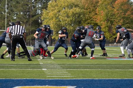 Alumni, students and employees play a game of football for the Homecoming 2021 Buster Bowl. - Photo by Abigail Aspinwall