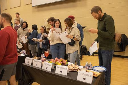 Judges for the Residence Life cooking event, Chomped, fill out their judging forms. - Photo by Abigail Aspinwall