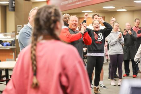 Staff members cheer for students as they arrive to Food for Finals.  - Photo by Kristi McMurry Woody