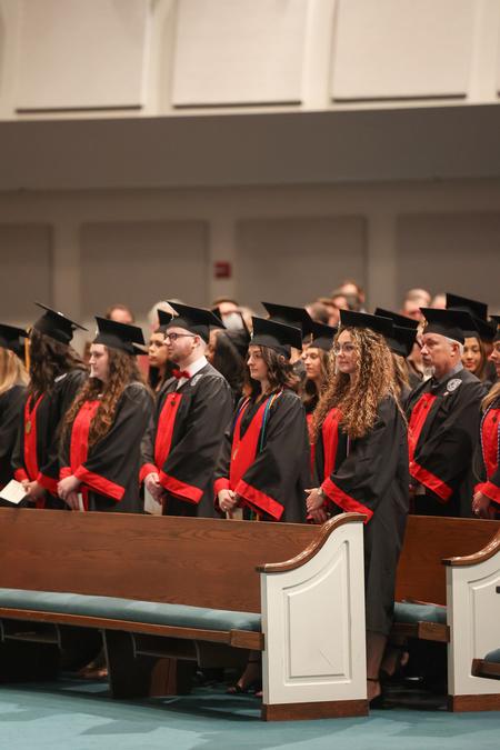 Students stand during the processional for fall graduation. - Photo by Kristi McMurry Woody