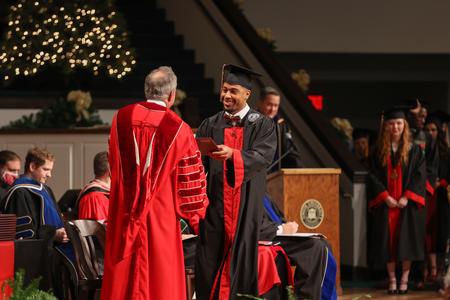 Tyree Boykin, business administration graduate, receives his diploma during Fall Commencement Services. - Photo by Kristi McMurry Woody