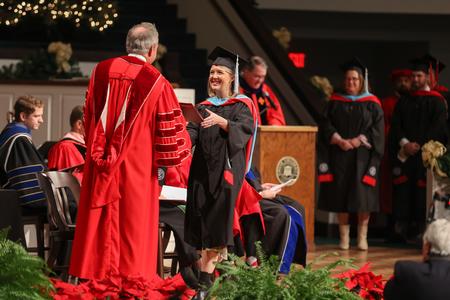 Meredith Kee, master of education graduate, receives her diploma during fall graduation. - Photo by Kristi McMurry Woody