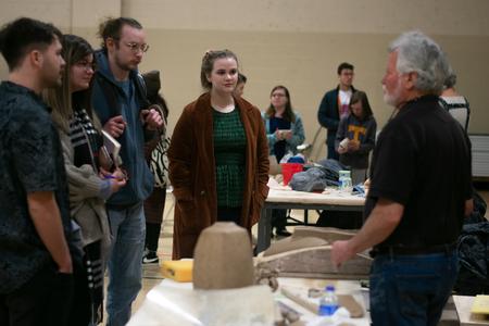 Students chat with artist Randy Johnston during a ceramics workshop. - Photo by Faith Orr