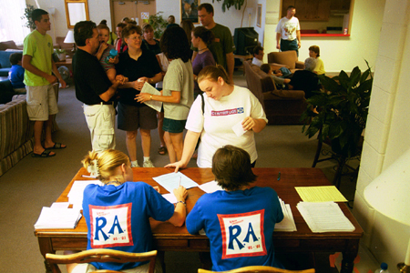 Freshmen and their families are greeted by Resident Assistants (RAs) as they arrive to move in to their new dorm rooms. - Photo by Justin Veneman