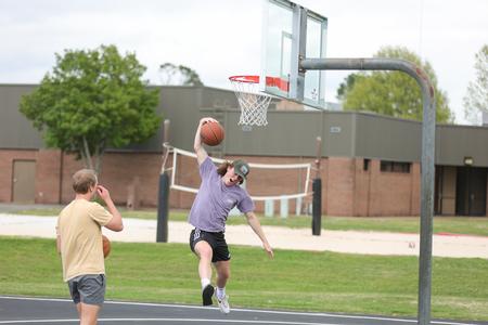 Justis Phegley and Tadd Binkley play basketball at ResLife's Field Day event. - Photo by Eli Creasy