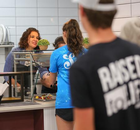5/17/22 - Erin Slater, director for the center for academic success, serves students a late-night breakfast during the annual Food for Finals event. - Suzanne Rhodes