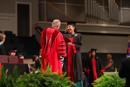 Candice Greshaw, BSOL graduate, receives her diploma from President Dub Oliver. - Photo by Suzanne Rhodes