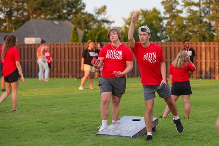 New students enjoy cornhole during Welcome Week at the annual ice cream party, hosted at Union president Dub Oliver's house. - Photo by Suzanne Rhodes