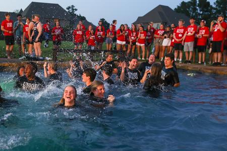 Welcome Week leaders jump into the pool at President Oliver's house during the annual Welcome Week ice cream party. - Photo by Suzanne Rhodes