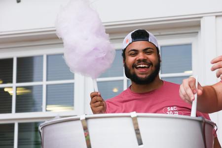Union junior, Jeremiah Chapman, serves cotton candy to UU's newest students during Welcome Week's SAC Fest event. - Photo by Suzanne Rhodes