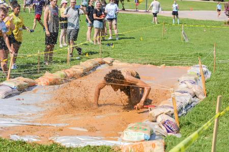 Student Nathan Nuulimba races through the mud pit portion of ResLife's annual 1/2K competition. - Photo by Suzanne Rhodes
