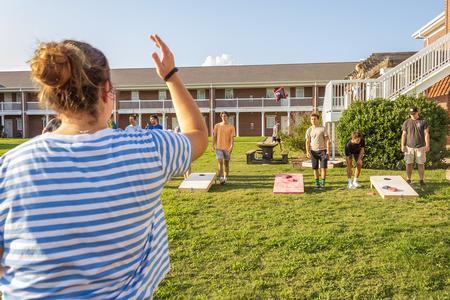 Students play cornhole on the Grace Quad during ResLife's Labor Day Block Party. - Photo by Abigail Aspinwall