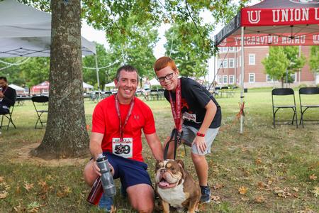 Jason Vaughan, director of development, participates in Buster's Bicentennial 5K with his son, as part of Union's bicentennial kick-off celebration. - Photo by Kristi McMurry Woody