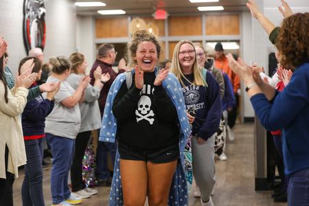 Student Rachel Mitchell is greeted by faculty and staff members cheering on students during the bi-annual Food for Finals event. - Photo by Suzanne Rhodes