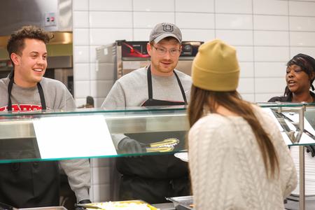 Staff Members Gage Gwartney and Joe Ball serve students a late-night breakfast during the bi-annual Food For Finals event. - Photo by Suzanne Rhodes