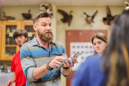 Micah Fern teaches his zoology students about alligator conservation