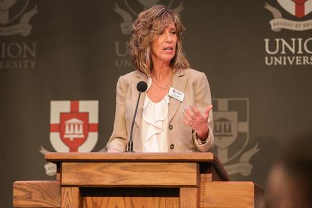 Karen Miller, interim dean for the McAfee School of Business, introduces Frank Harrison, CEO of Coca-Cola Consolidated, for the annual Faith in the Marketplace luncheon. - Photo by Suzanne Rhodes