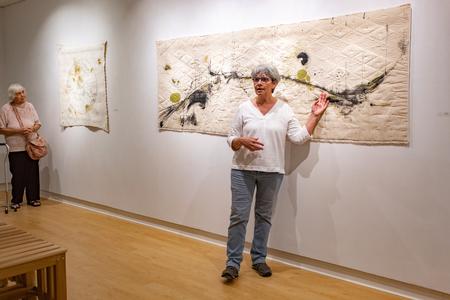 Paula Kovarik, full-time artist and fiber art workshop teacher from Memphis, Tenn., presented a lecture on her recent exhibit in the art gallery that featured her stitching art. - Photo by Lyla Dietz