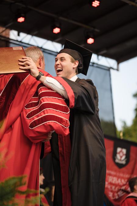 Austin Stacks, an accounting major from Henderson, Tenn., gets a hug from President Oliver during Spring Graduation. - Photo by Kristi McMurry Woody