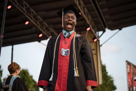 5/6/23 - Steve Williams, a business administration major from Memphis, Tenn., celebrates as he crosses the stage at Spring Graduation. - Kristi McMurry Woody