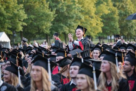 Trenton Golds, a political science major from Wilksboro, N.C., cheers for a fellow graduate at Spring Graduation. - Photo by Kristi McMurry Woody