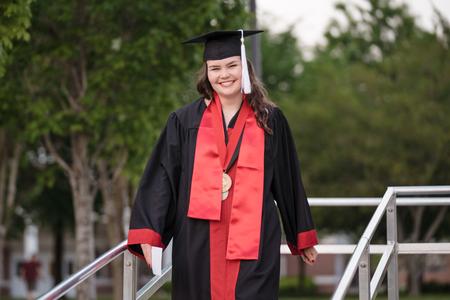 Anna Moss, a Christian studies major from Bells, Tenn., smiles as she returns to her seat after being awarded the 113th Tigrett Medal, which is awarded to an outstanding senior in each graduating class, during Spring Graduation.  - Photo by Kristi McMurry Woody