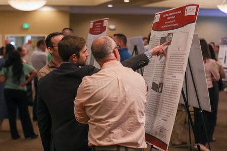 Engineering major Timothy Boccarossa explains one of his two poster presentations at the 2023 UUSS. This poster presentation was entitled "Using COMSOL to Model Particle Flow Through a Digital Twin Design." - Photo by Eli Creasy