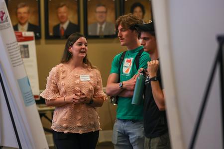 Chemistry major Elizabeth Smith explains her poster presentation entitled "Chromatographic Analysis of Common Analgesic Compounds Using TLC, LC, and HPLC" at the 2023 UUSS. - Photo by Eli Creasy