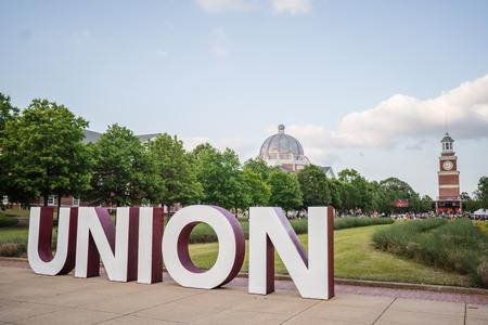 Spring Graduation on the Great Lawn with the new Union Letters feature in the foreground. - Photo by Kristi McMurry Woody