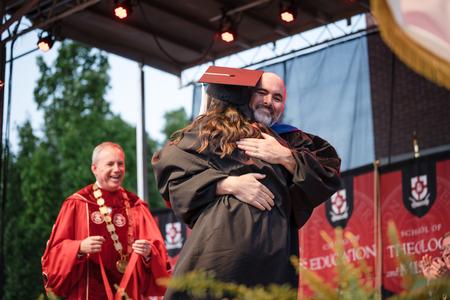 George Moss, professor of mathematics, hugs his daughter Anna after she was awarded the the 113th Tigrett Medal at Spring Graduation. - Photo by Kristi McMurry Woody