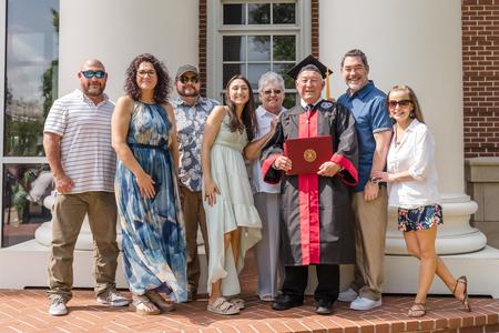 Seventy-two year old pastor James Ramsey, BSOL graduate in church leadership from McMinnville, Tenn., poses with his family after the spring graduation ceremony. - Photo by Kristi McMurry Woody