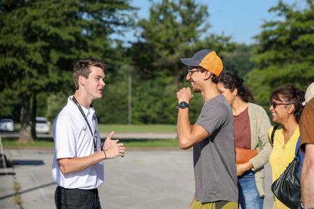 Welcome Week Leader Hayden Phillips welcomes a new student at check-in on Move-In Day. - Photo by Karley Hathcock