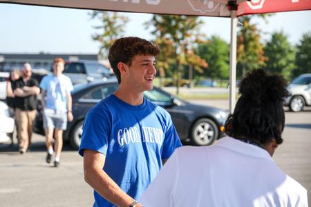 Freshmen Paxton Harwell talks with Welcome Week leaders at check-in during Move-In Day. - Photo by Karley Hathcock