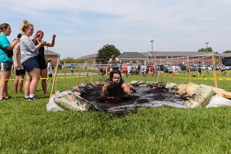 Students dive into the mud pit during the Residence Life Half K. - Photo by Karley Hathcock