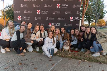 10/31/23 - The women of Chi Omega take a photo with Buster (the second) at his retirement party during Homecoming 2023. - Lauren Steed