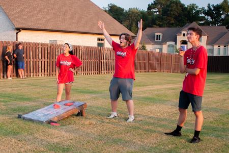 New Bulldogs enjoy a game of corn hole at President Oliver's home during Welcome Week. - Photo by Lauren Steed