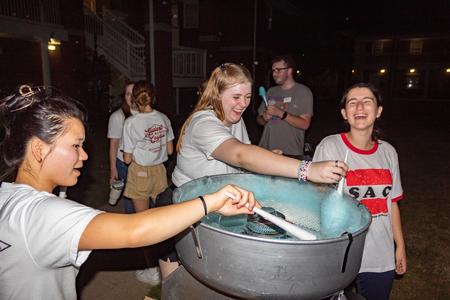 Members of SAC spin up some cotton candy during the Movie on the Lawn during Family Weekend. - Photo by Lyla Dietz