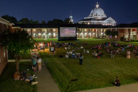 Families enjoy a movie during SAC's Movie on the Lawn during Family Weekend. - Photo by Lyla Dietz