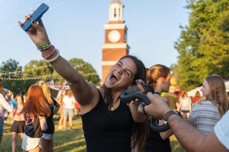 The Union community enjoyed getting to interact with various departments on campus at Union Night during Family Weekend. Here a student gets a chance to interact with a snake featured by the Biology department's Critter Club. - Photo by Lauren Steed