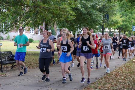 Families enjoy a morning run together in Buster's Annual 5K Dash during Family Weekend. - Photo by Karley Hathcock