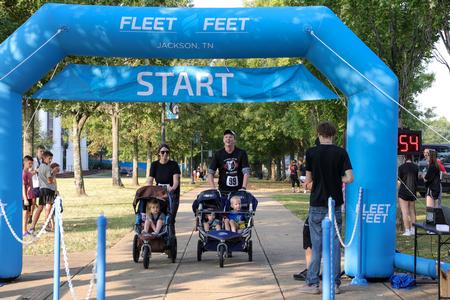 Michael Lewis, CRM & Business Solutions Administrator, finishes Buster's Annual 5K Dash with his family during Family Weekend. - Photo by Karley Hathcock