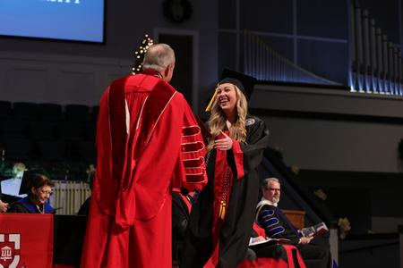 Alivia Montgomery smiles as she receives her bachelor of social work degree at the fall undergraduate commencement ceremony. - Photo by Karley Hathcock