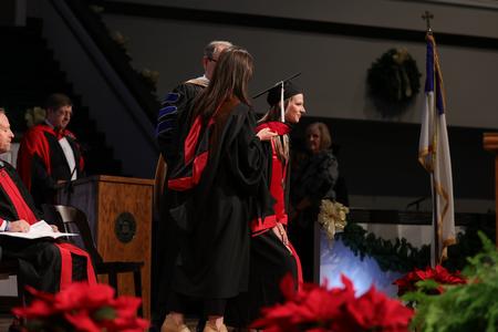 Gabrielle Berry receives her honors hood and bachelors degree in Biblical Studies/Languages at the fall undergraduate commencement ceremony. - Photo by Karley Hathcock
