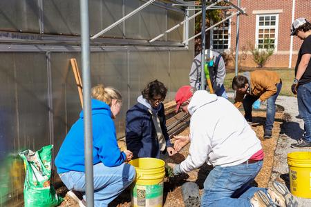 10/31/23 - Professor Mark Bolyard demonstrates a planting technique for students outside the Biology greenhouse during Campus and Community Day. - Karley Hathcock