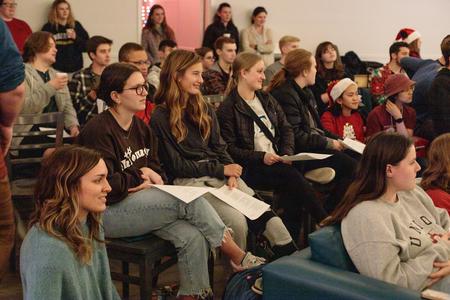 Union students listen in as Dub and Susie Oliver read The Night Before Christmas during Christmas with the Olivers in the McAfee Commons. - Photo by Lindsey Atwood