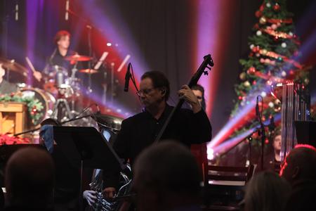 Tim Smith, assistant professor of commercial music performance and technology, plays with the orchestra during A Union Christmas. - Photo by Karley Hathcock